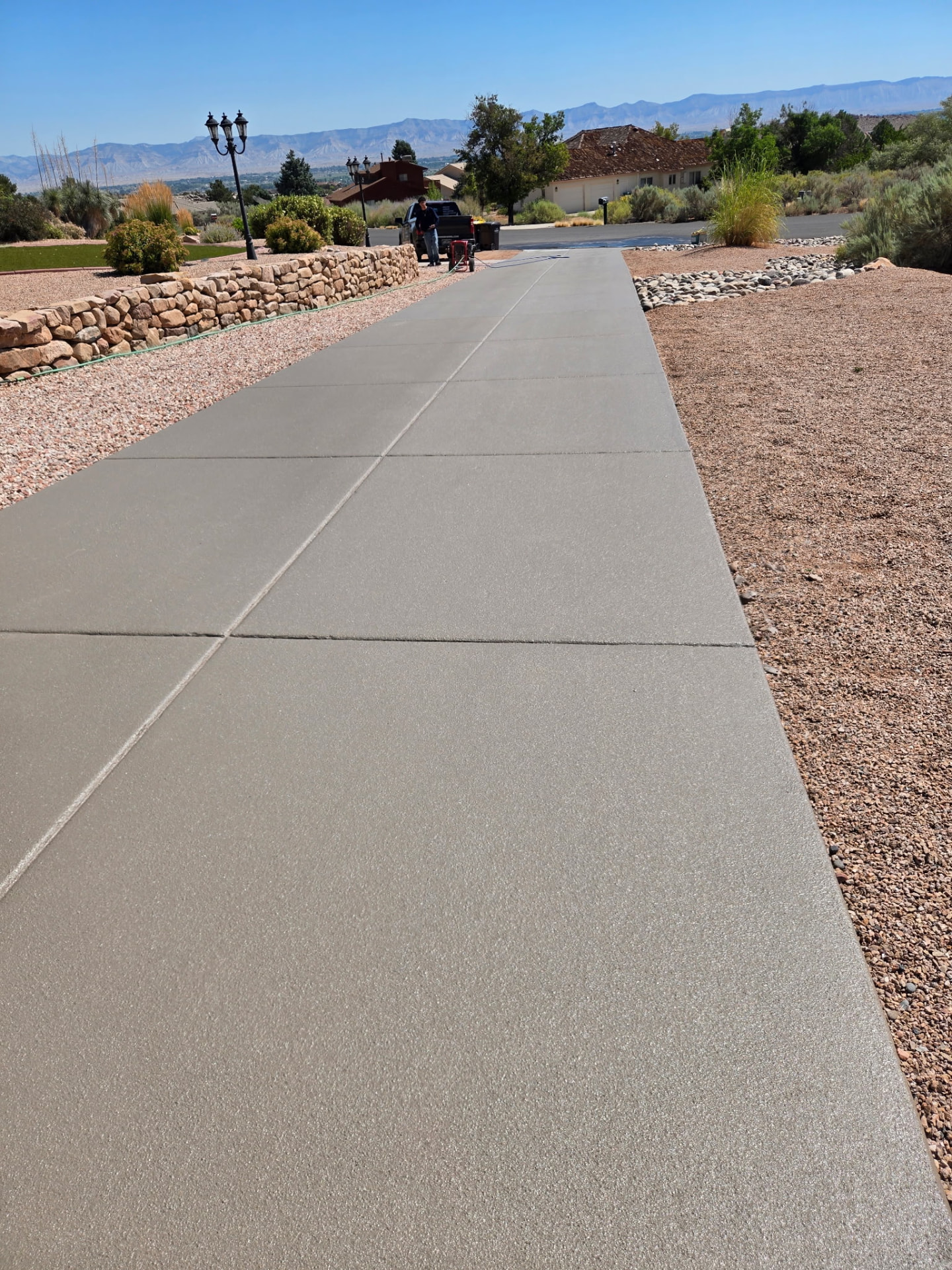 Freshly sealed concrete driveway with Colorado mountains in the background