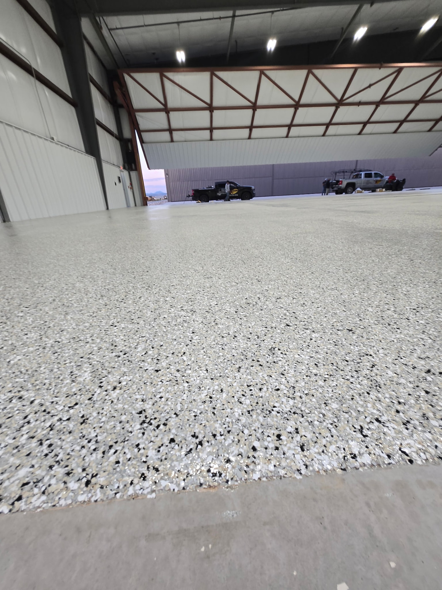 Large warehouse interior with epoxy flake floor coating by Adrian's Sealants