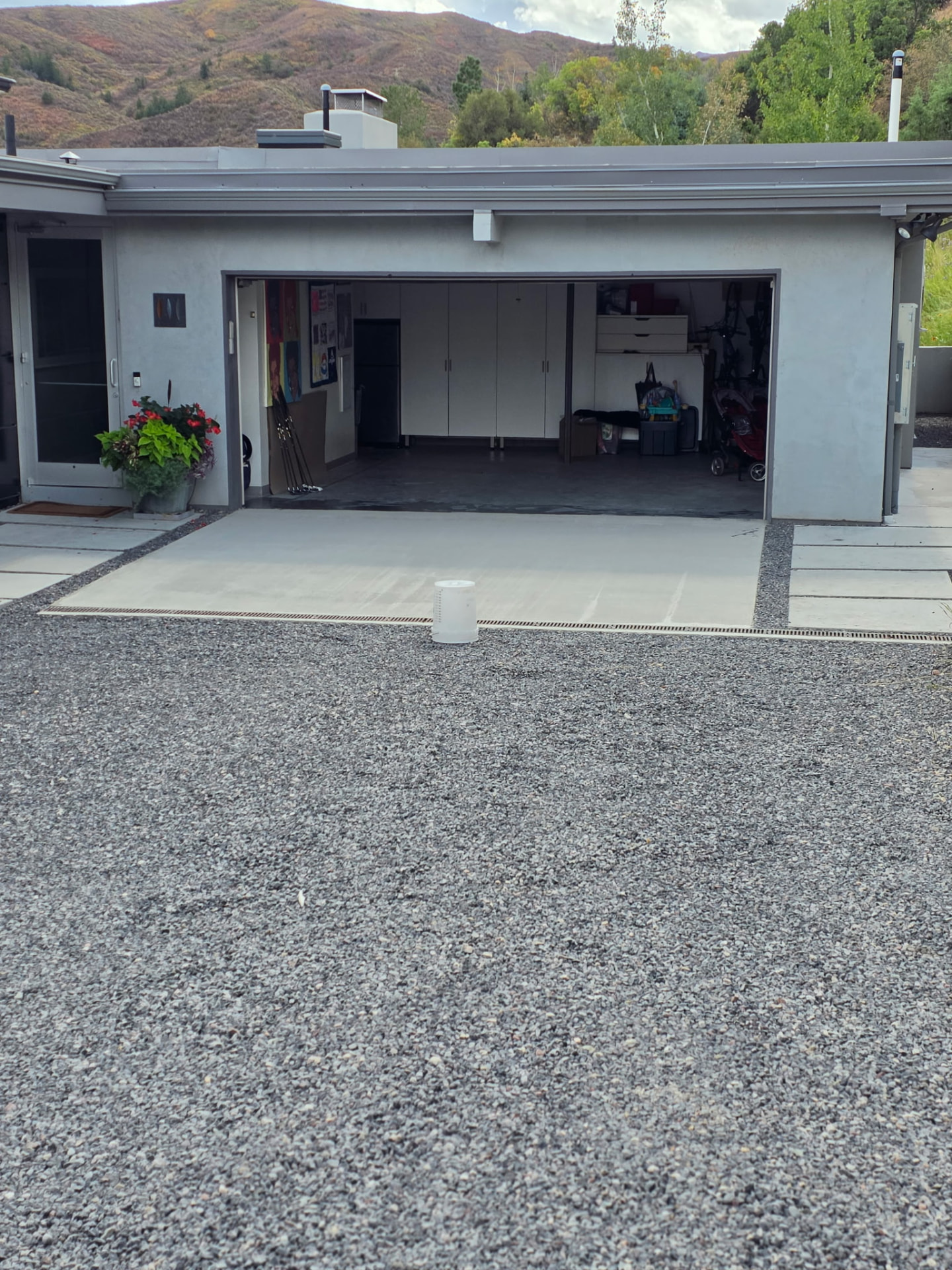 Completed and repaired concrete driveway apron with mountain views behind the home